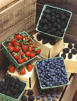 Blackberries, blueberries, and strawberries in containers