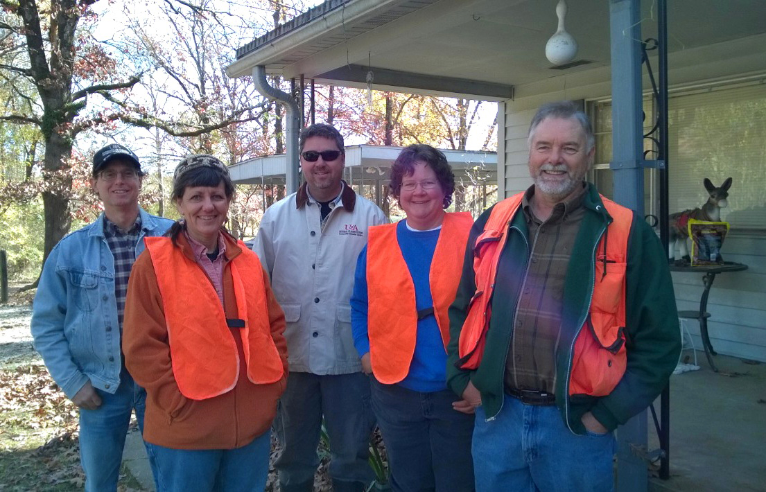 Image of coworkers wearing orange safety vests