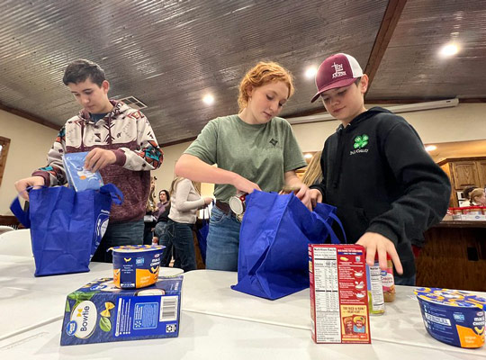 polk county 4-hers packing supplies for the needy