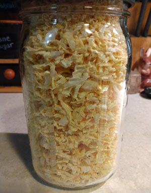 quart sized canning jar containing dehydrated minced onion.