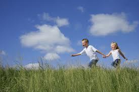 Air Quality | Environment & Nature | Arkansas Extension - blue sky, happy girl and boy holding hands while running in field of tall grass