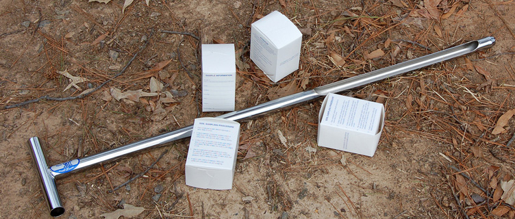 Soil probe and boxes for soil samples on the ground