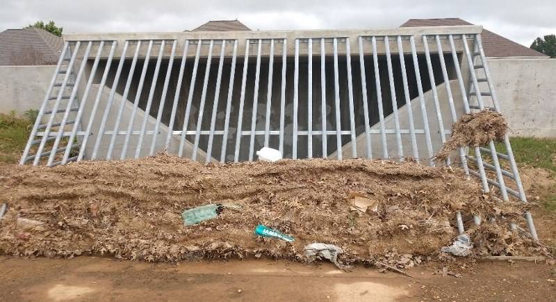 Grass clippings washed to detention basin and cause near by streets and home to flood during a heavy rain event. Rogers, AR.  