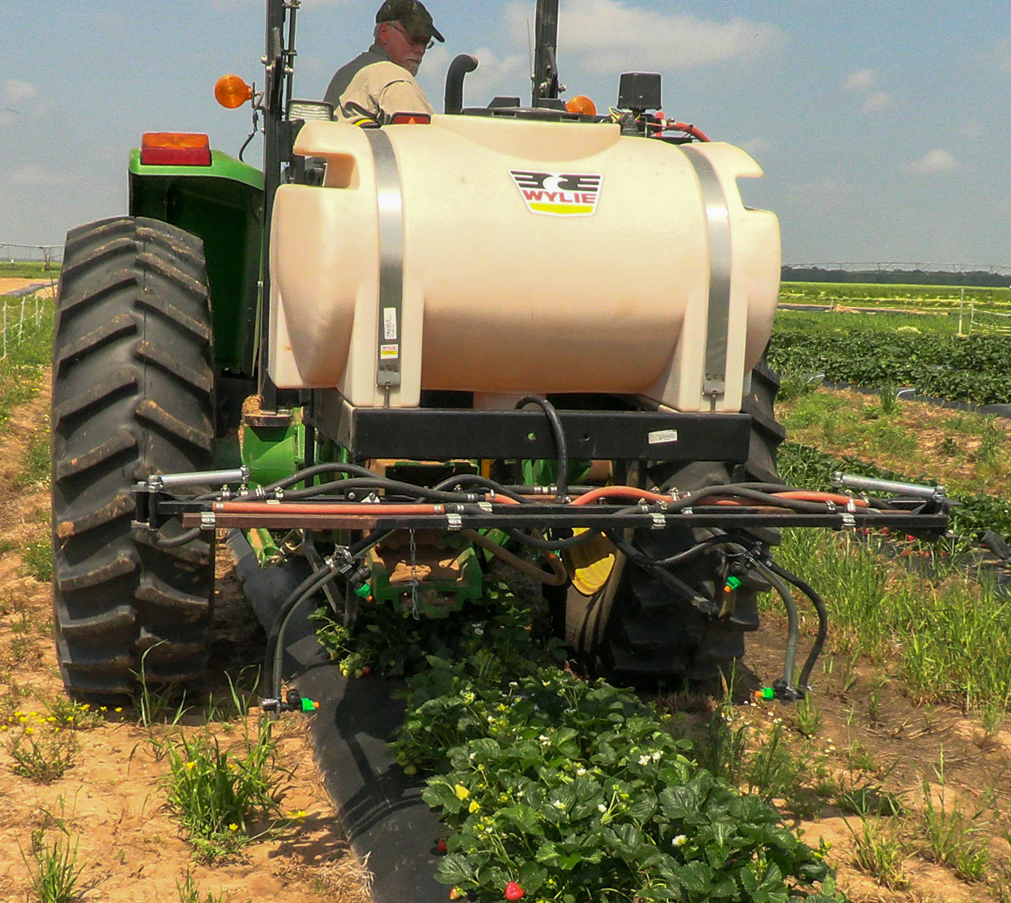 Strawberry sprayer attached to an existing tractor mounted boom sprayer. By changing the hose connections, you retain the ability to use both sprayers. 