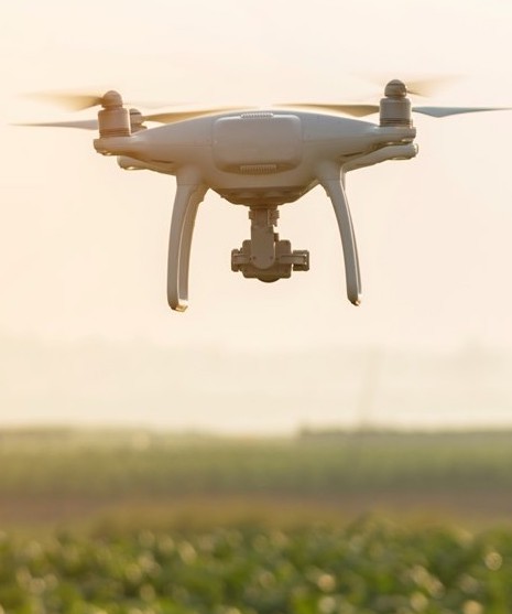 Drone hovering above field