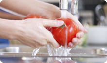 washing tomatoes in running water